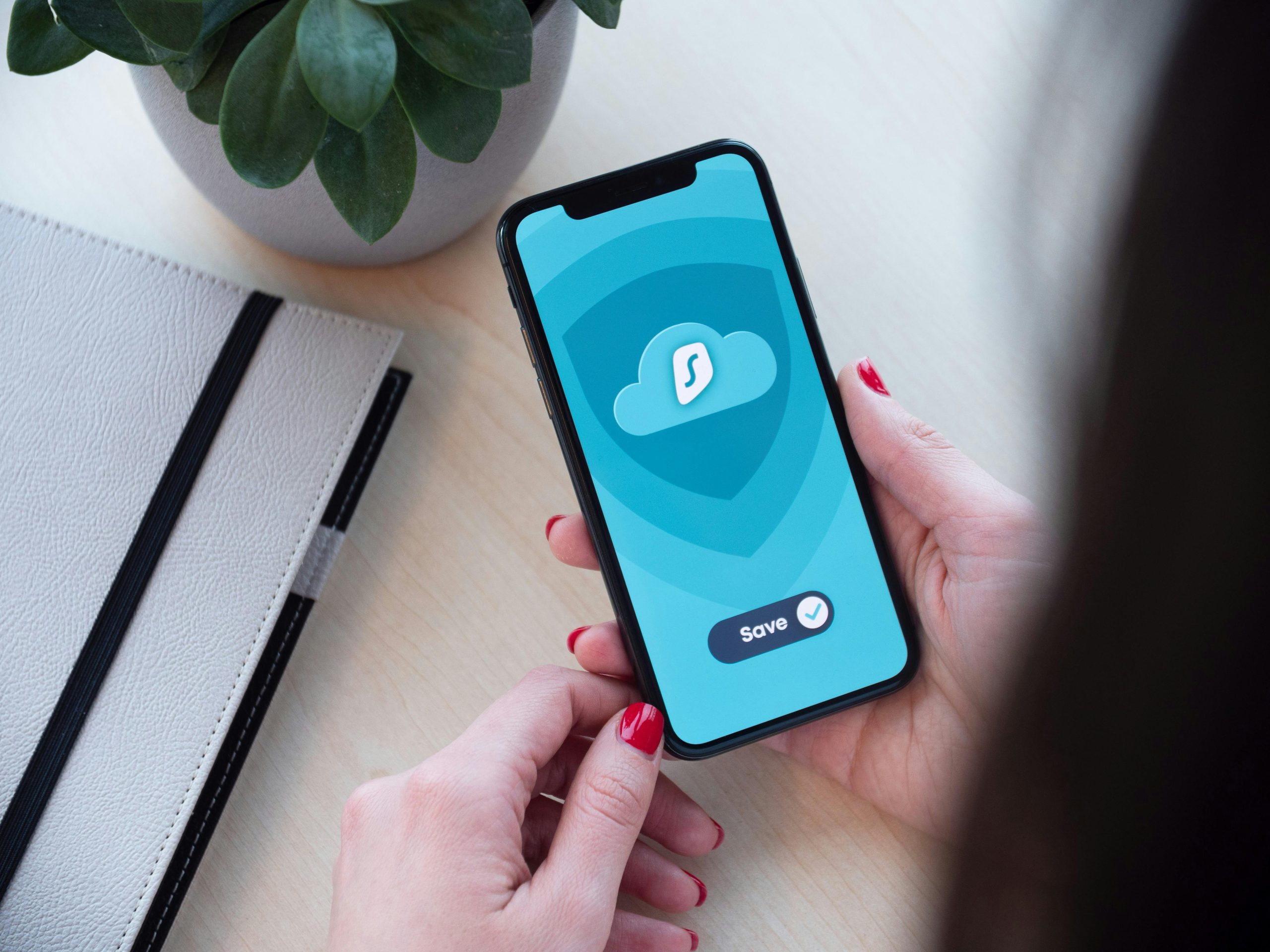 Hand holding a smartphone displaying a streaming app - legal alternatives
